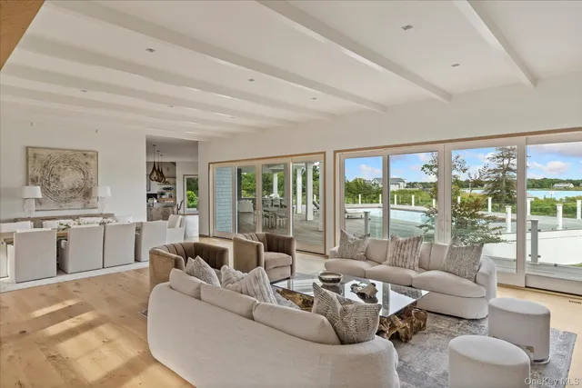 a living room with furniture and floor to ceiling windows