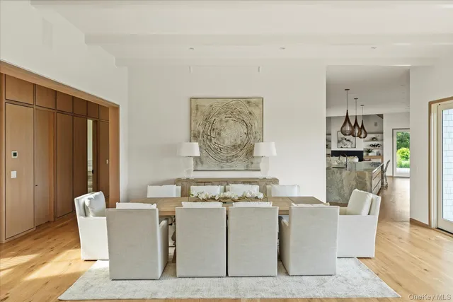 a living room with furniture a dining table and a refrigerator