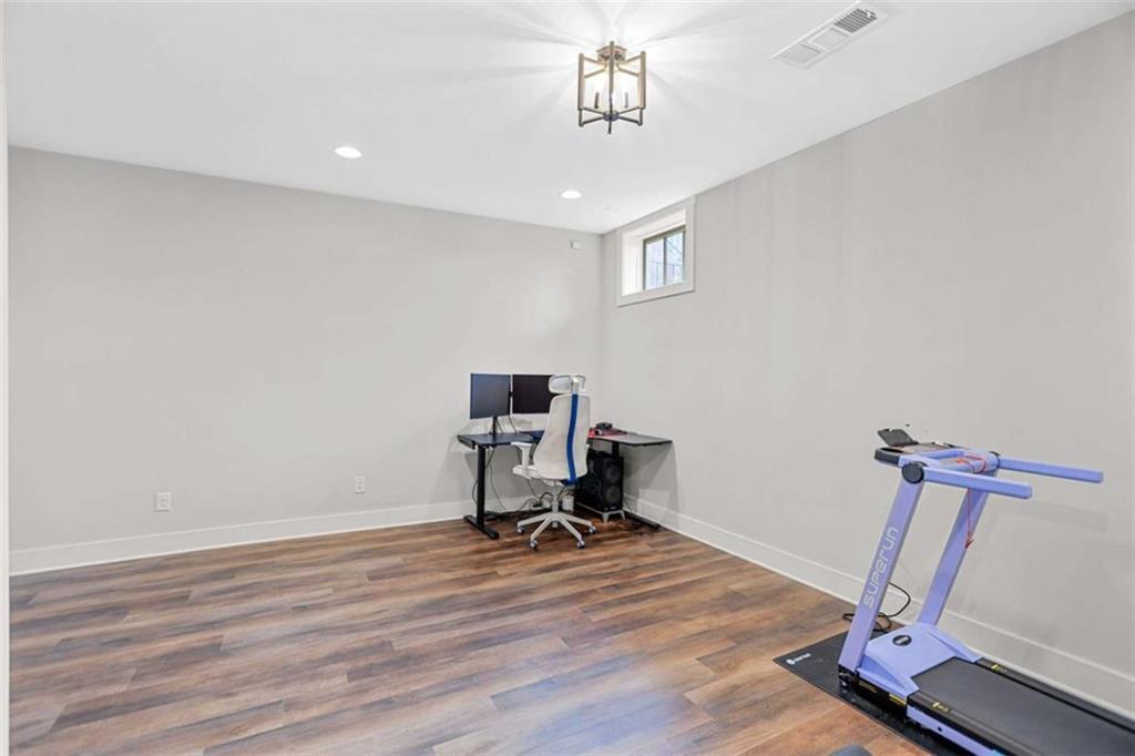 4466 Lemon Street Acworth, GA 30101 - Photo 32 of 65 a view of a workspace with furniture and wooden floor