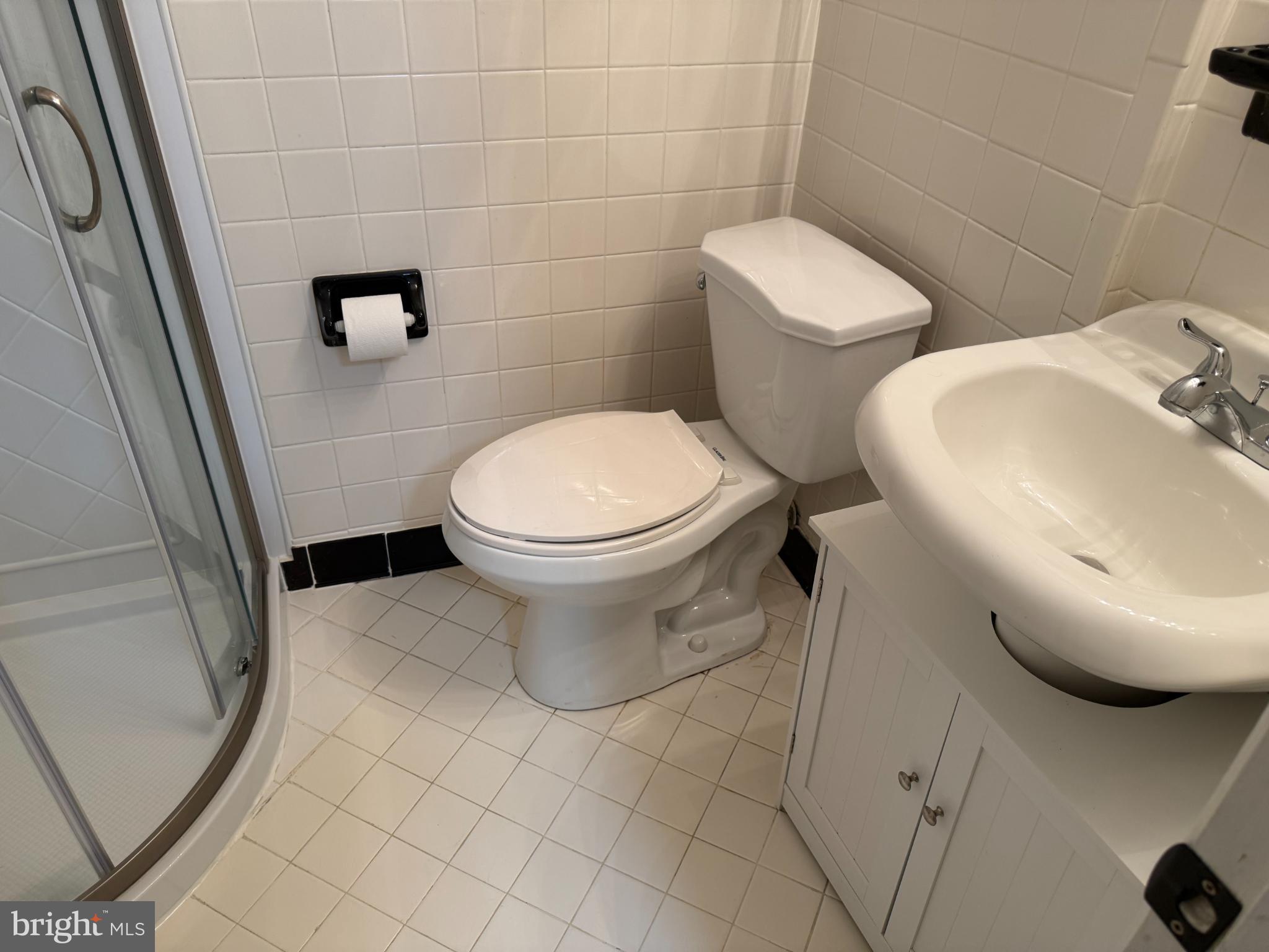 4640 31st Road South, Unit A1 Arlington, VA 22206 - Photo 10 of 15 a white toilet sitting next to a bathroom sink