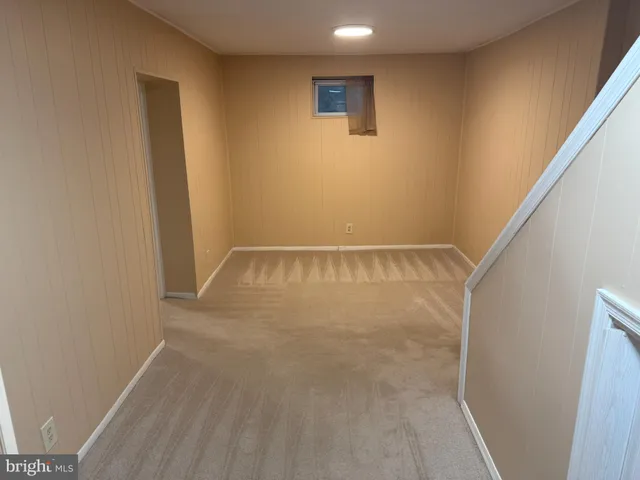 a view of a room with wooden floor and window