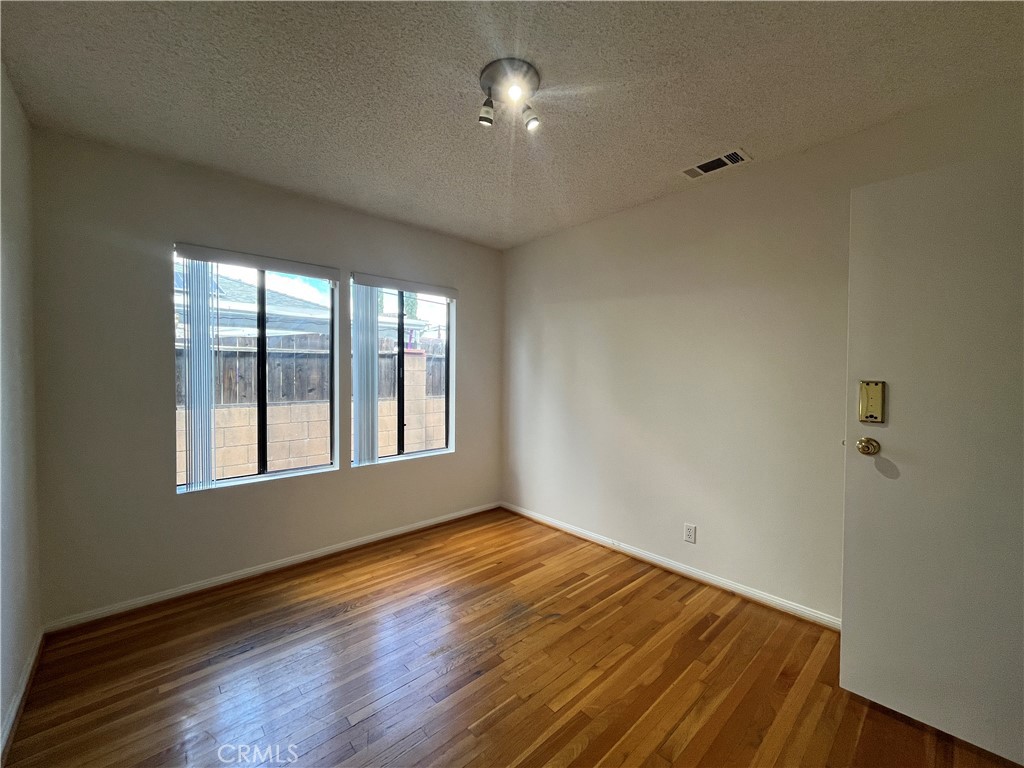 18029 Santa Rita Street Encino, CA 91316 - Photo 7 of 20 a view of empty room with wooden floor and fan