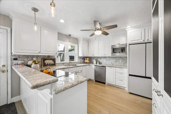 a kitchen with stainless steel appliances granite countertop a sink and stove top oven