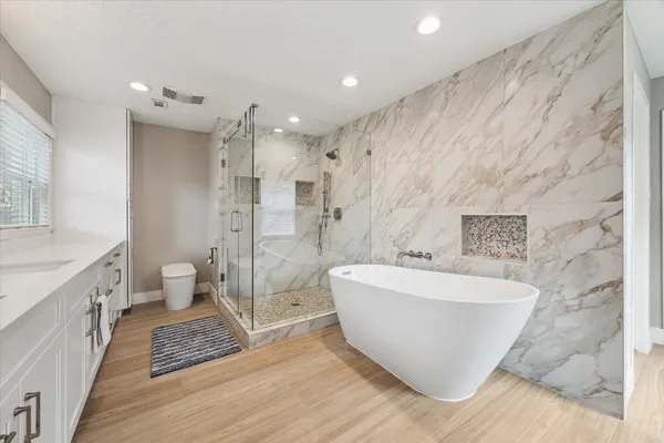 a bathroom with a sink mirror and vanity