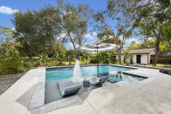 a view of a patio with table and chairs with wooden fence and plants