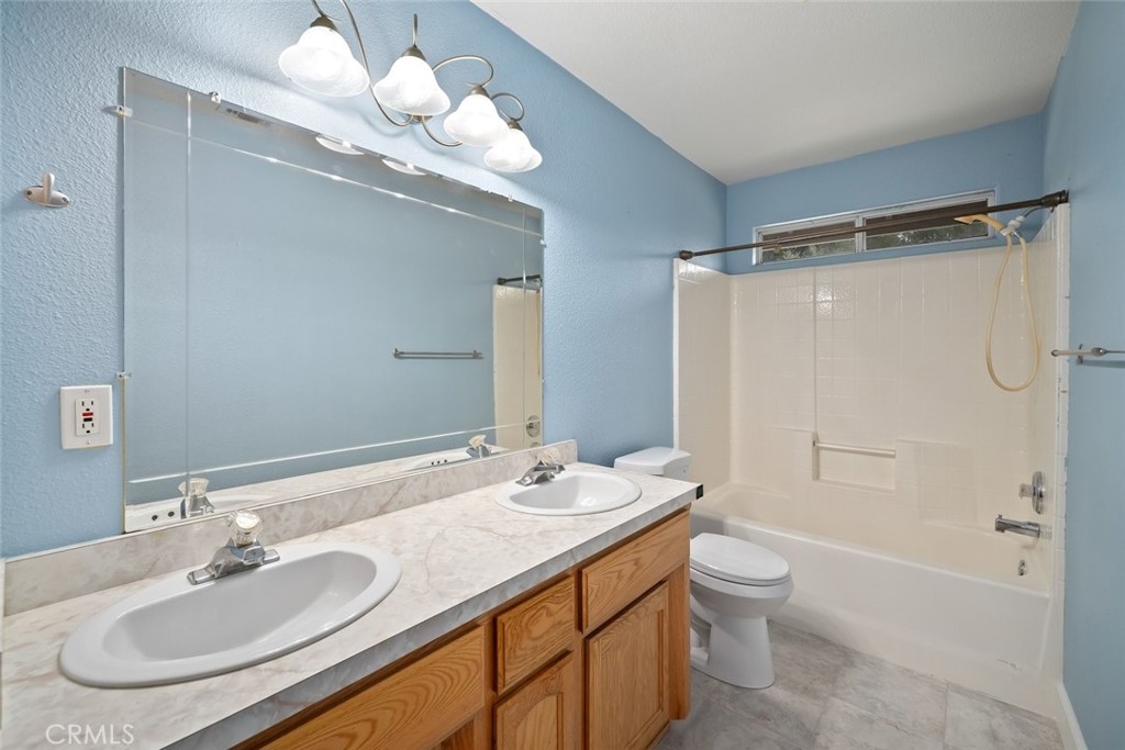 3735 Monterey Road Atascadero, CA 93422 - Photo 24 of 33 a bathroom with a granite countertop sink a toilet and shower