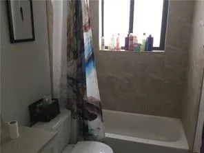a bathroom with a bathtub and a window