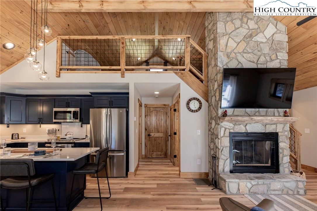Lot 3 Old Hampton Road Boone, NC 28607 - Photo 15 of 32 a view of a kitchen with stainless steel appliances kitchen island granite countertop a refrigerator and a fireplace