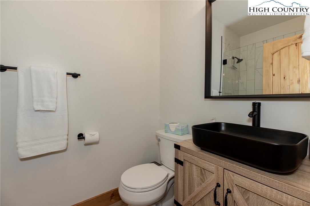 Lot 3 Old Hampton Road Boone, NC 28607 - Photo 26 of 32 a bathroom with a toilet a sink and mirror