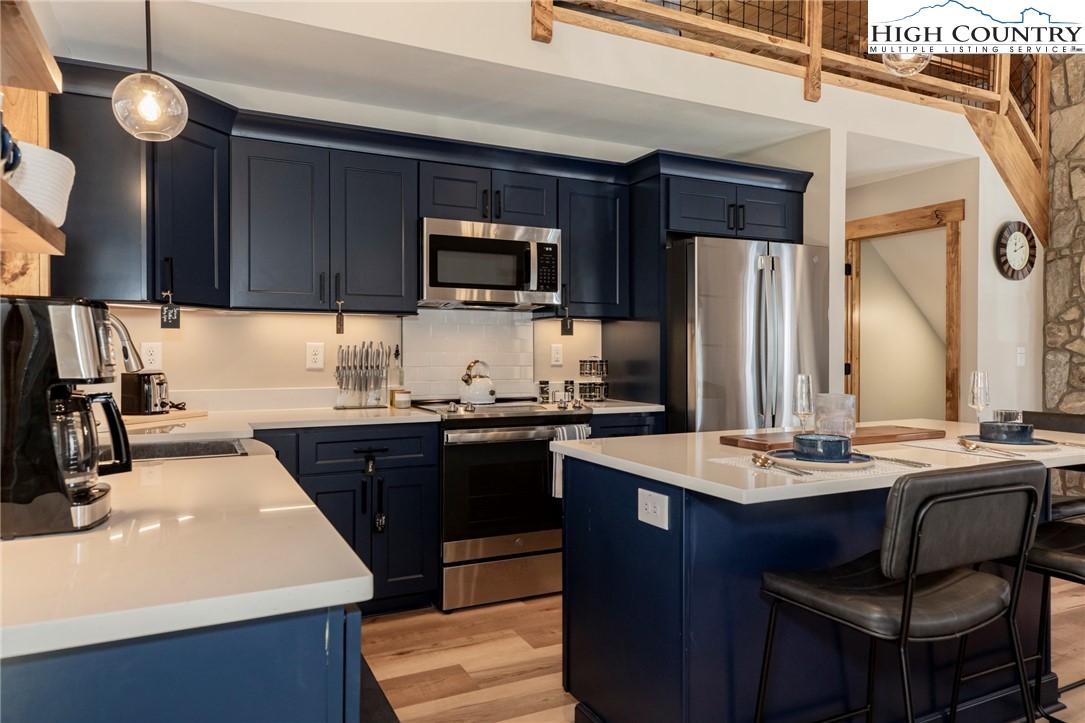 Lot 3 Old Hampton Road Boone, NC 28607 - Photo 9 of 32 a kitchen with stainless steel appliances a sink a stove a refrigerator cabinets and a dining table