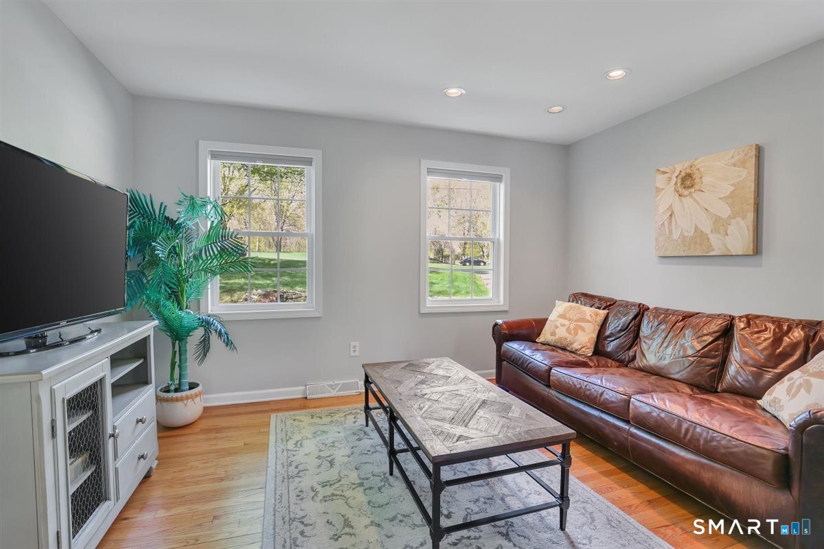 9 Academy Road Trumbull, CT 06611 - Photo 15 of 35 a living room with furniture and a flat screen tv