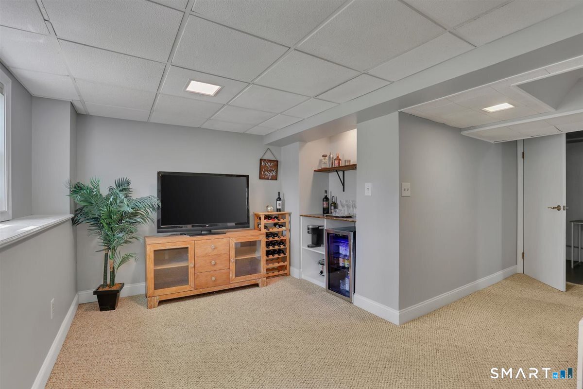 9 Academy Road Trumbull, CT 06611 - Photo 19 of 35 a view of a livingroom with furniture and a flat screen tv