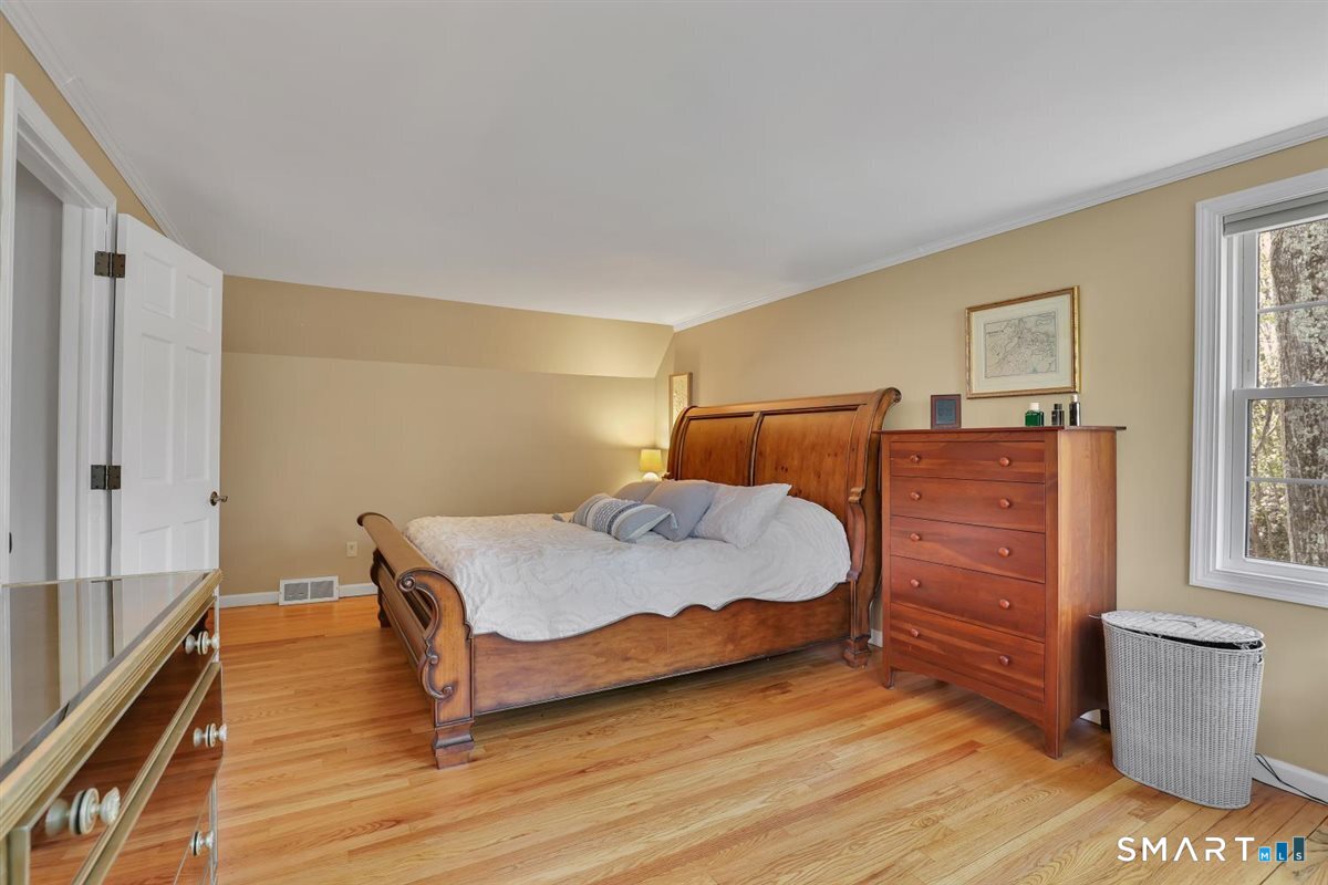 9 Academy Road Trumbull, CT 06611 - Photo 21 of 35 a bedroom with a bed and wooden floor