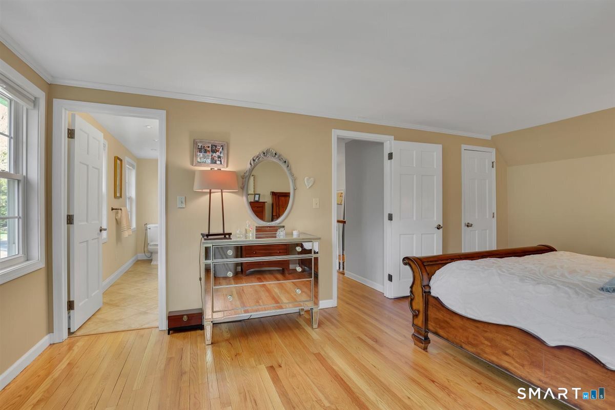 9 Academy Road Trumbull, CT 06611 - Photo 23 of 35 a bedroom with furniture and a wooden floor