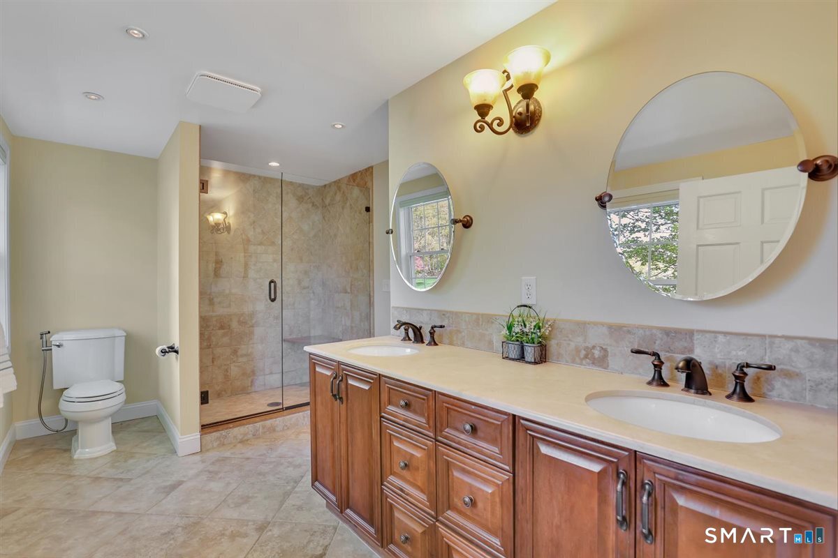 9 Academy Road Trumbull, CT 06611 - Photo 24 of 35 a bathroom with a double vanity sink and a mirror