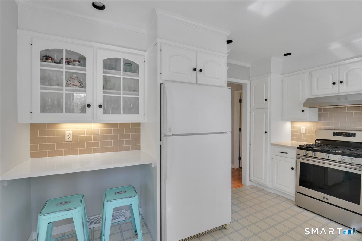 9 Academy Road Trumbull, CT 06611 - Photo 9 of 35 a kitchen with cabinets appliances and a window