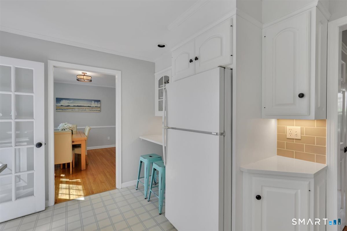 9 Academy Road Trumbull, CT 06611 - Photo 10 of 35 a white refrigerator freezer and a window