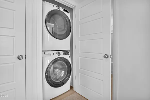 a view of a storage and utility room with washer and dryer