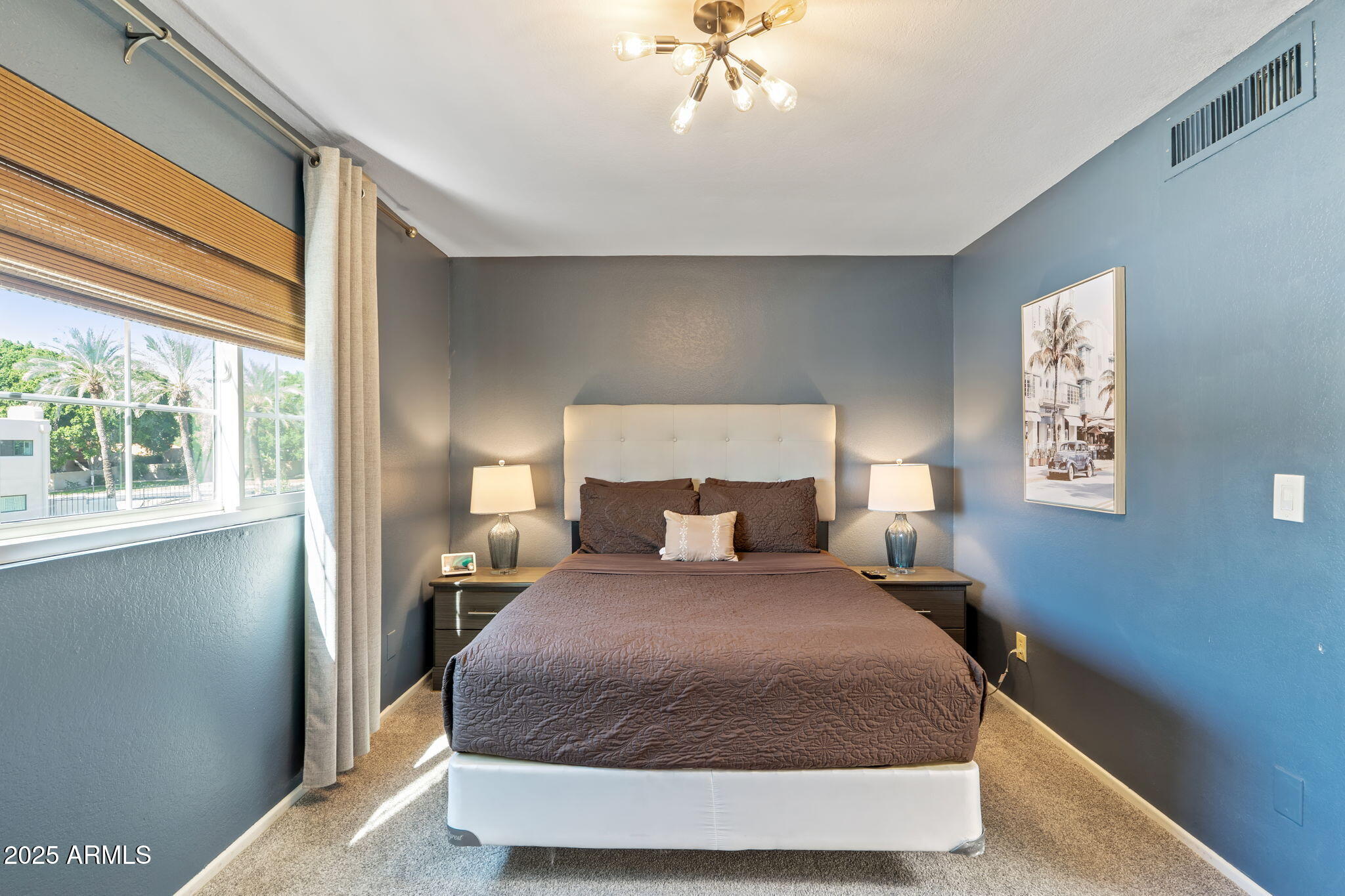 6229 North 30th Way Phoenix, AZ 85016 - Photo 33 of 58 a bedroom with a large bed and a chandelier