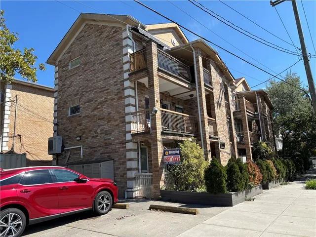 a view of a car parked in front of a building