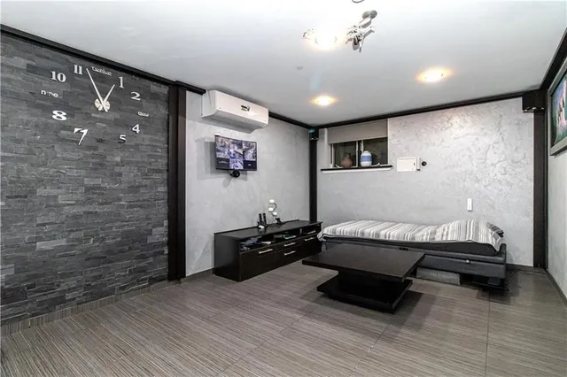 a spacious bedroom with a bed and a couch