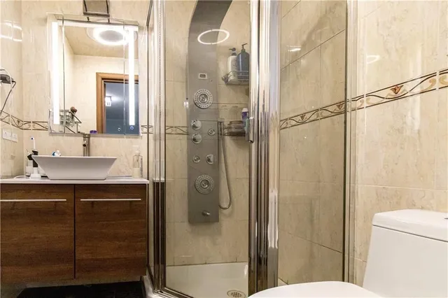 a bathroom with a shower a sink and a mirror
