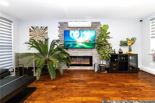 a living room with furniture a fireplace and a potted plant