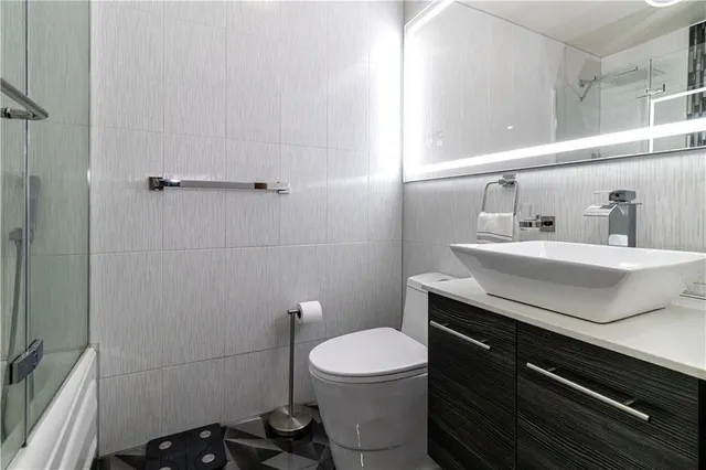 a bathroom with a sink toilet and vanity