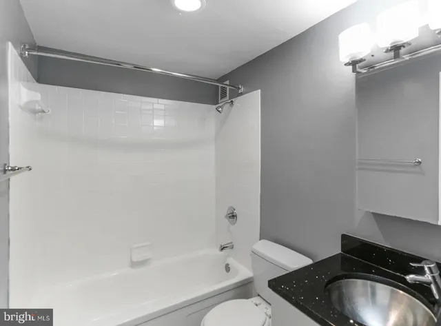 a bathroom with a toilet and a shower curtain