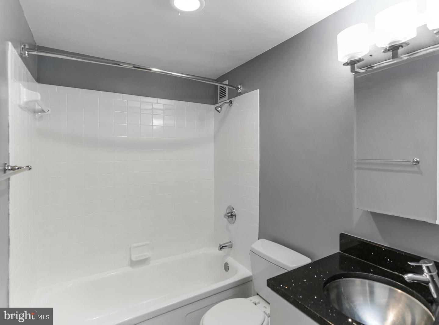 1101 3rd Street Southwest, Unit 403 Washington, DC 20024 - Photo 11 of 73 a bathroom with a granite countertop sink toilet and shower