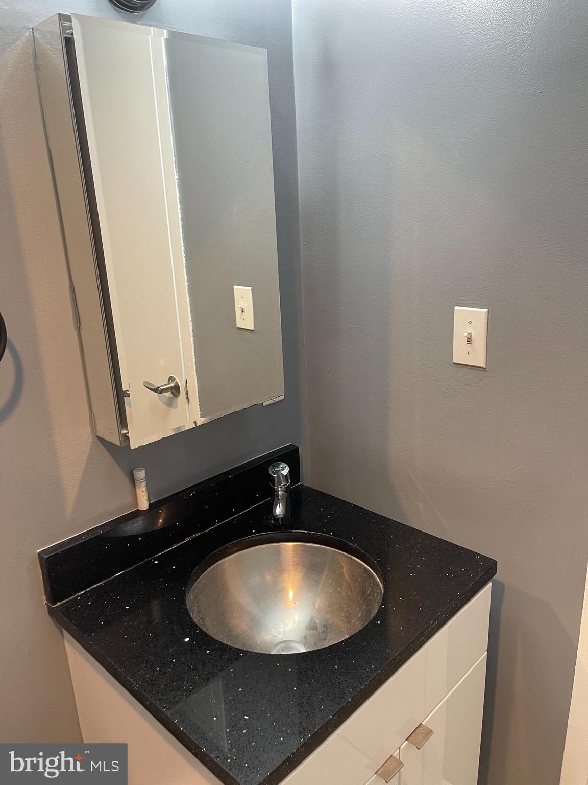 1101 3rd Street Southwest, Unit 403 Washington, DC 20024 - Photo 14 of 73 a bathroom with a granite countertop sink and a mirror