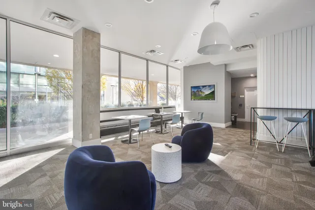 a living room with furniture a dining table and kitchen view