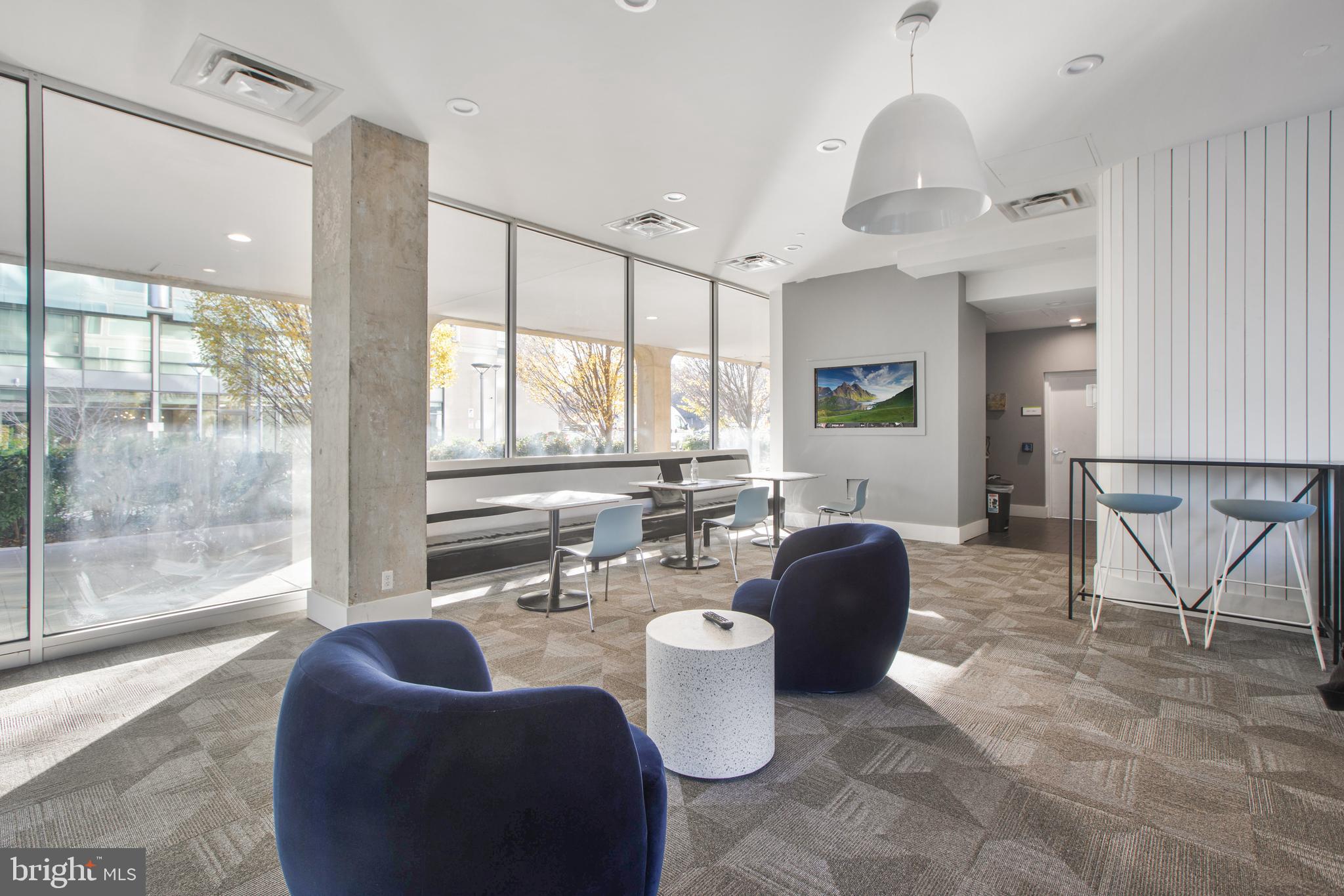 1101 3rd Street Southwest, Unit 403 Washington, DC 20024 - Photo 19 of 73 a living room with furniture and a large window