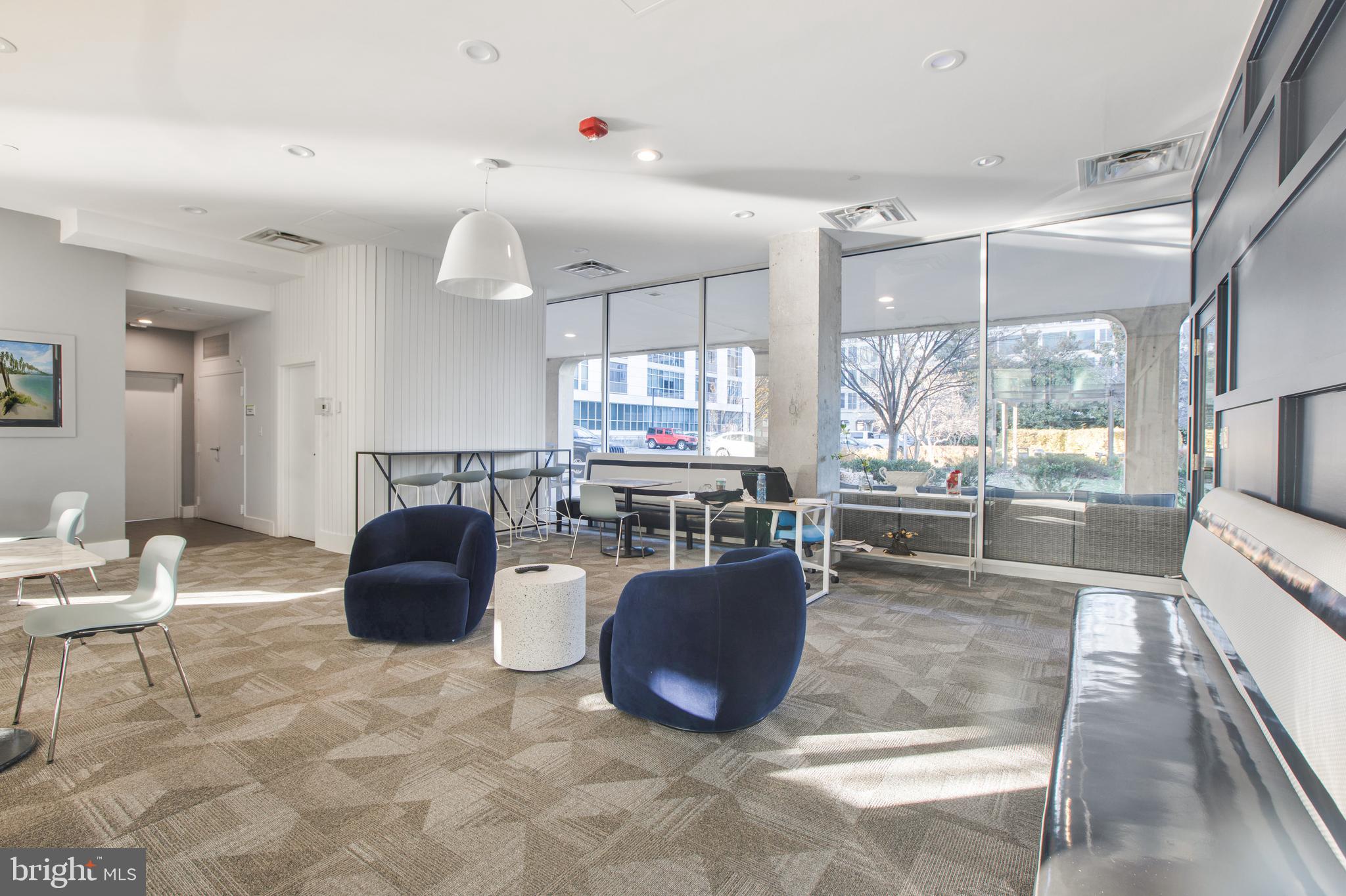1101 3rd Street Southwest, Unit 403 Washington, DC 20024 - Photo 20 of 73 a living room with furniture a dining table and kitchen view