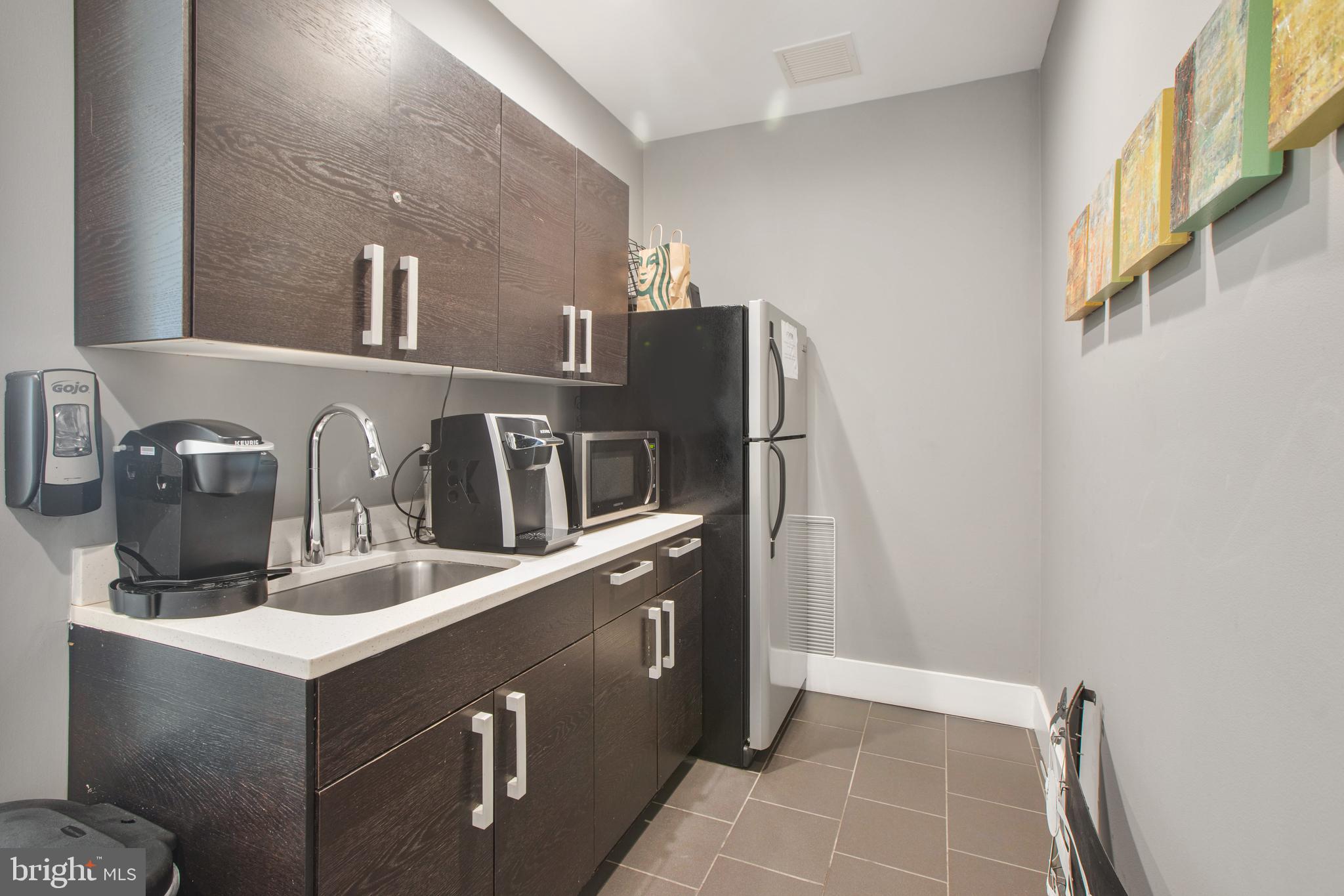 1101 3rd Street Southwest, Unit 403 Washington, DC 20024 - Photo 23 of 73 a kitchen with stainless steel appliances granite countertop a sink and a refrigerator