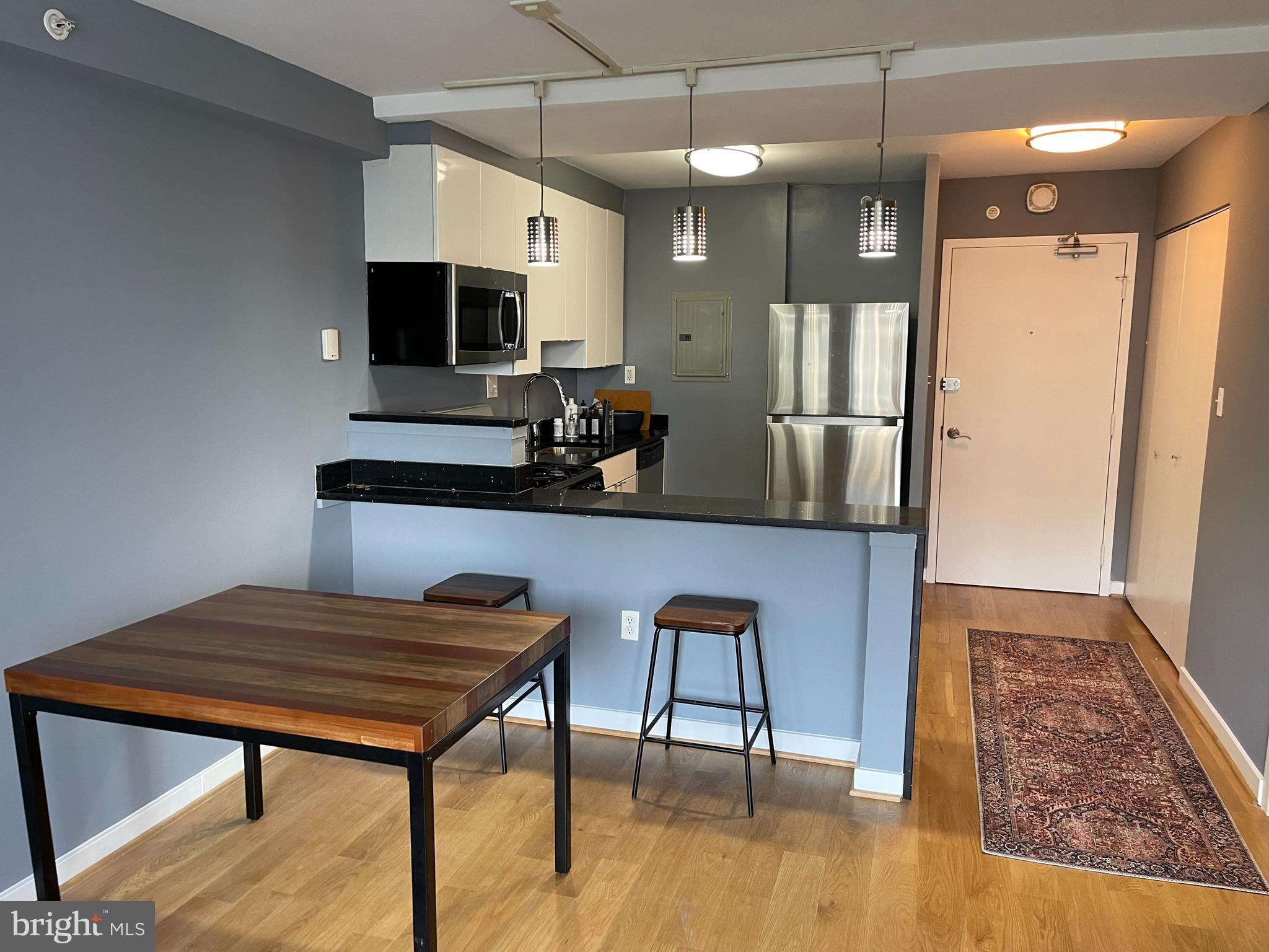 1101 3rd Street Southwest, Unit 403 Washington, DC 20024 - Photo 8 of 73 a view of dining room and wooden floor
