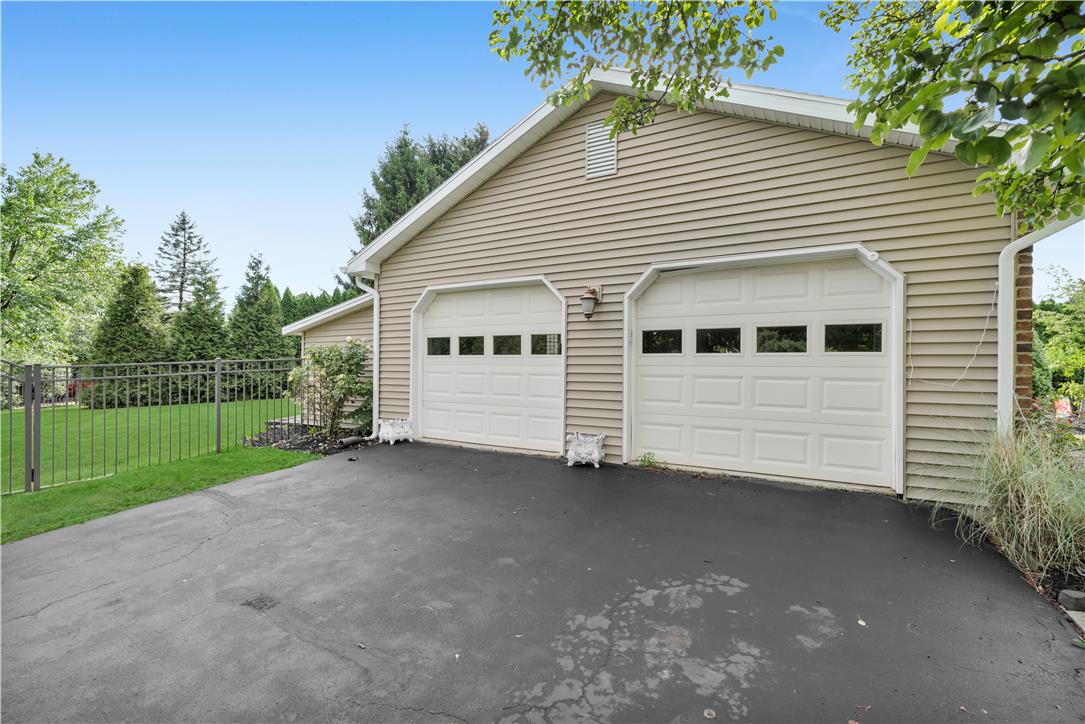 3396 Darien Road Bethlehem, PA 18020 - Photo 6 of 44 Two bright garage doors offer convenient parking, complementing the serene fenced yard.