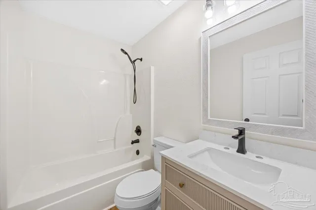 a kitchen with stainless steel appliances a refrigerator and a stove top oven