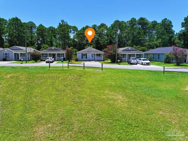 an aerial view of a house with a yard and garden