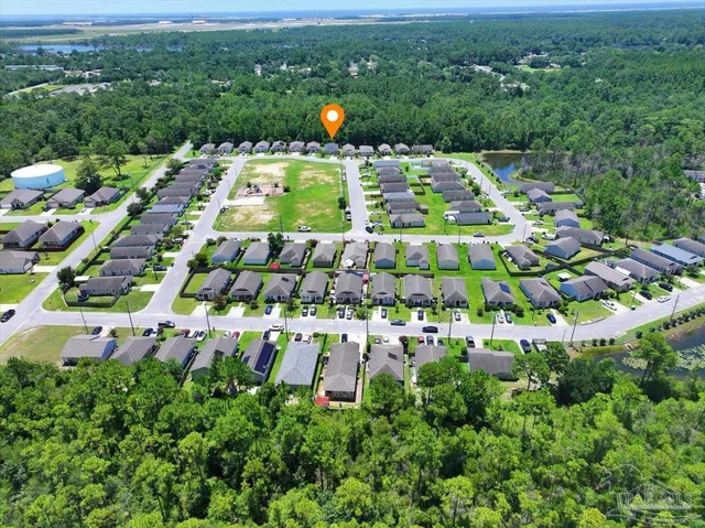 a view of yard with swimming pool and trees in the background