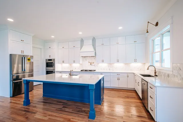 a kitchen with granite countertop a sink appliances cabinets and counter space