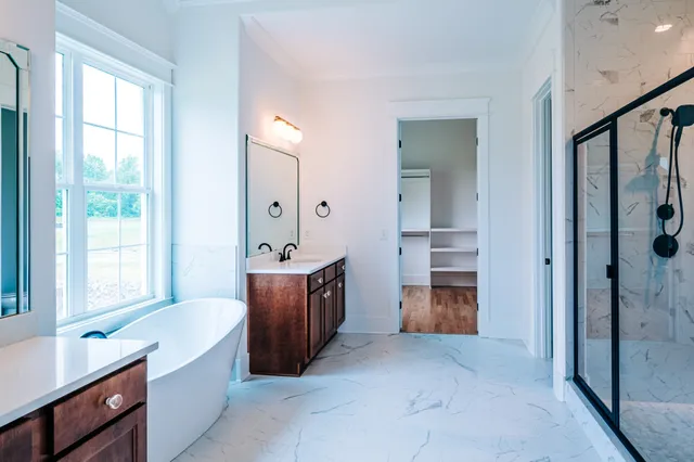 a large en suite bathroom with a tub shower and sink