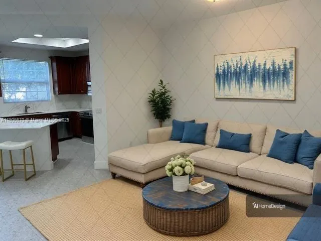 a living room with furniture and a kitchen