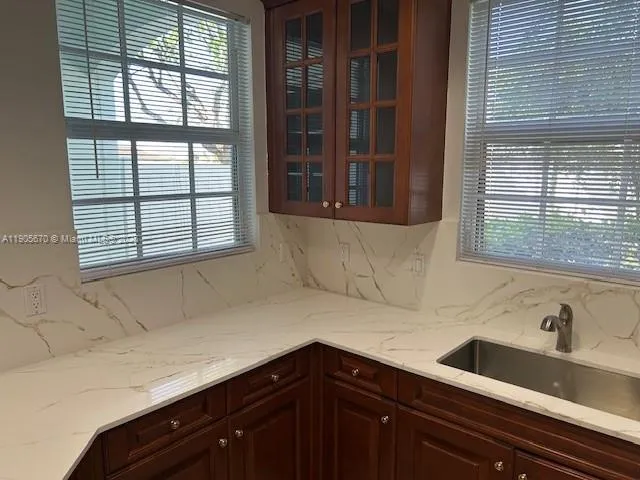 a bathroom with a sink and a window