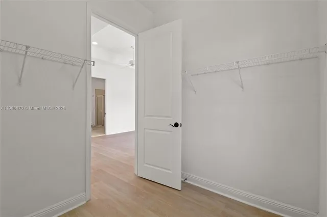 a view of a house with wooden fence