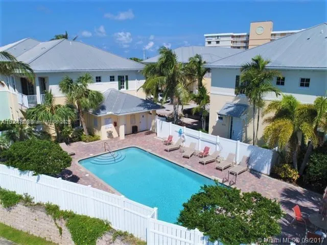 an aerial view of a house with swimming pool garden and patio