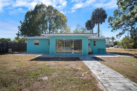 a front view of house with yard and trees