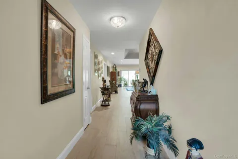 a view of a dining room with furniture a chandelier and wooden floor