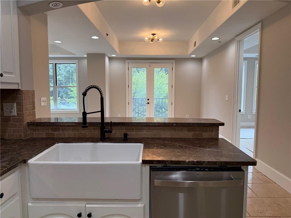 2255 Peachtree Road Northeast, Unit 322 Atlanta, GA 30309 - Photo 11 of 25 a view of a sink and dishwasher with wooden floor