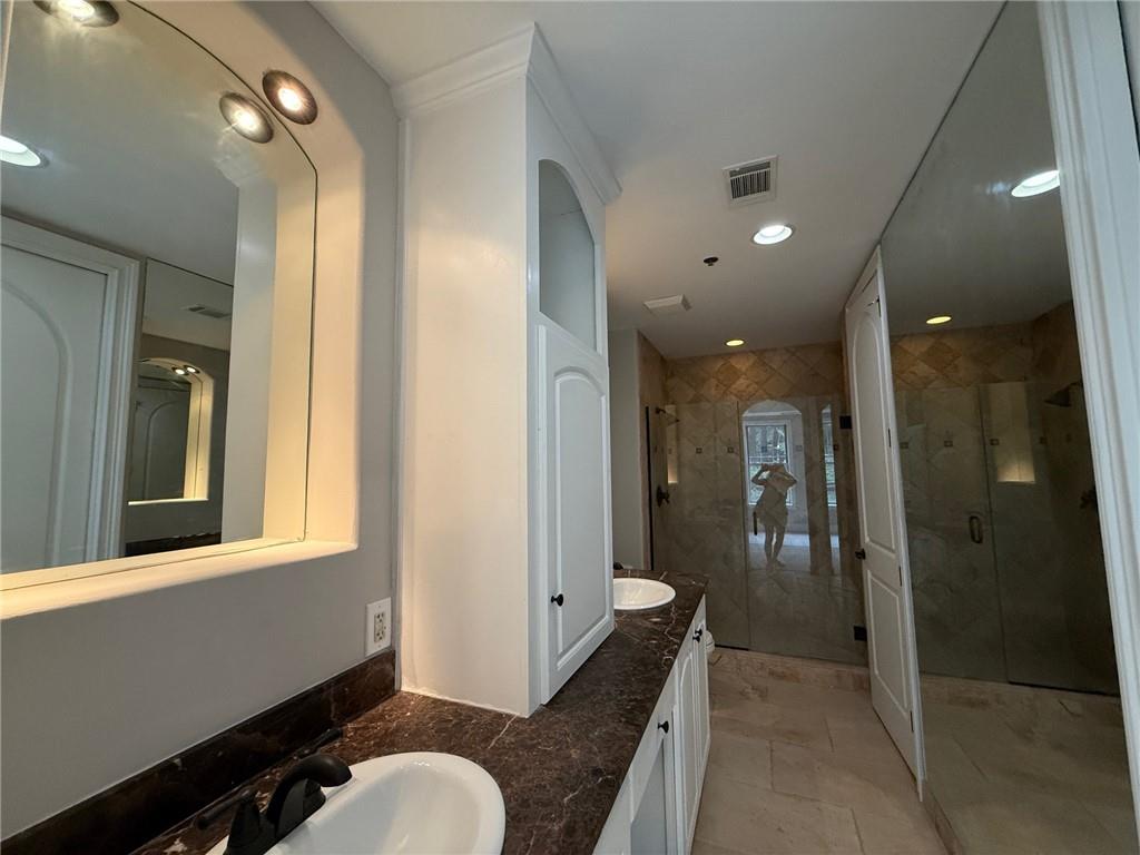 2255 Peachtree Road Northeast, Unit 322 Atlanta, GA 30309 - Photo 13 of 25 a bathroom with a sink and mirror